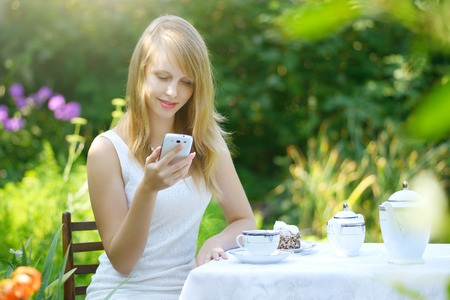 Pretty girl with mobile phone. Outdoorsの写真素材