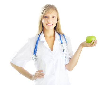 Portrait of a happy female doctor with green apple isolated on white backgroundの写真素材
