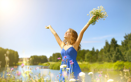 Beautiful girl with bunch of camomiles. countrysideの写真素材