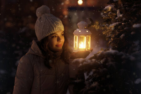 Cute girl with a lantern on dark backgroundの写真素材