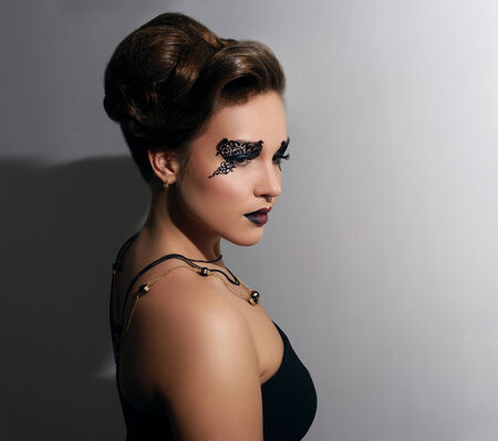 Attractive girl with beautiful makeup on gray backgroundの写真素材