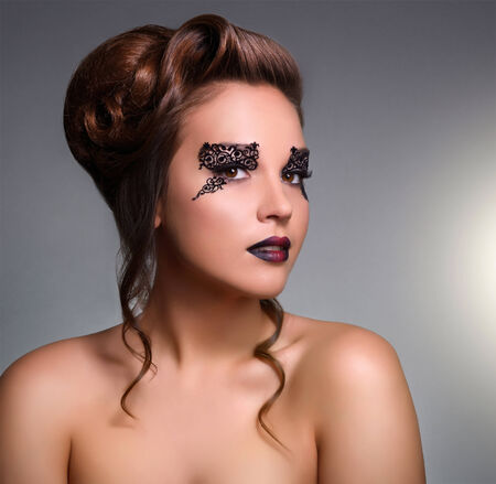 Attractive girl with beautiful makeup on gray backgroundの写真素材