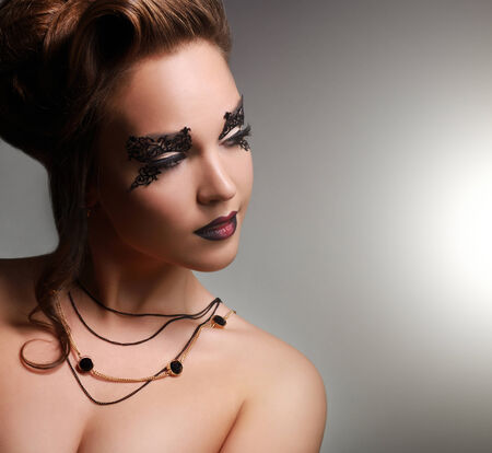 Attractive girl with beautiful makeup on gray backgroundの写真素材