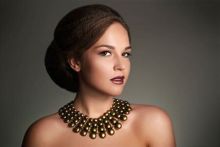 Young woman with beautiful makeup and retro hairstyle on gray backgroundの写真素材