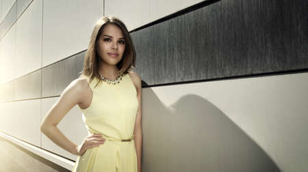 Attractive girl in a yellow dress. urban styleの写真素材