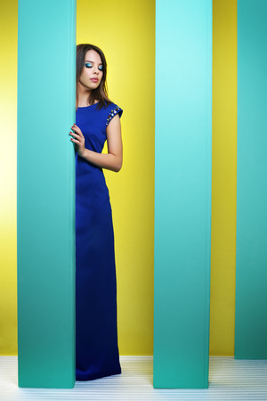 Attractive girl in a long dress on an abstract backgroundの写真素材