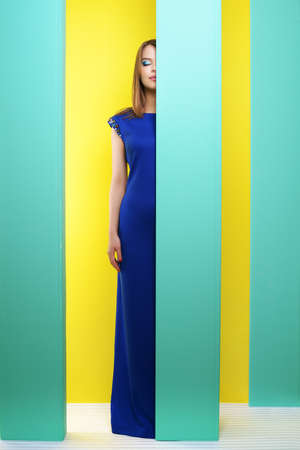 Attractive girl in a long dress on an abstract backgroundの写真素材