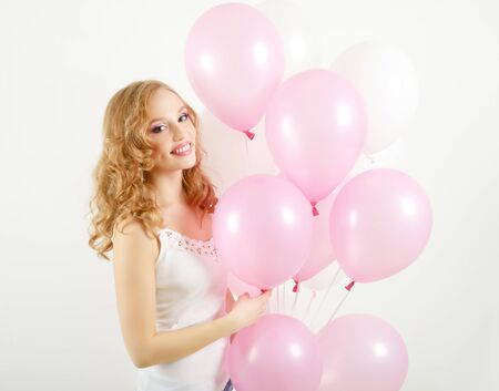 Girl with balloons on light backgroundの写真素材