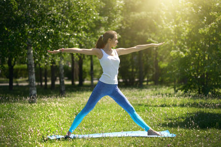 Pretty woman doing yoga exercises in the parkの写真素材