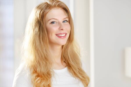 Smiling girl on a light backgroundの写真素材