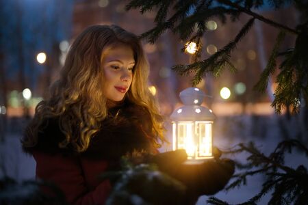 Cute girl with a lantern. Christmas girl with lanternの写真素材