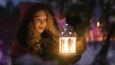 Cute girl with a lantern. Christmas girl with lanternの写真素材