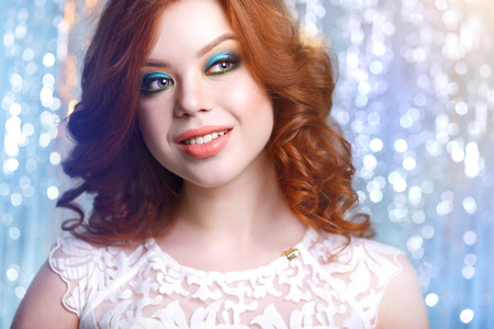 girl with curly hair on a light backgroundの写真素材
