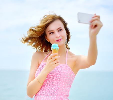 Smiling girl with ice cream. Outdoorsの写真素材