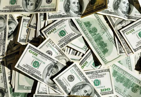 a lot of dollars in day light- useful as backgroundの写真素材
