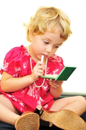 pretty little girl usinf mother's cosmeticsの写真素材