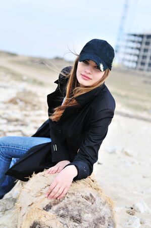 teen lovely girl on the beach , she is wearing capの写真素材