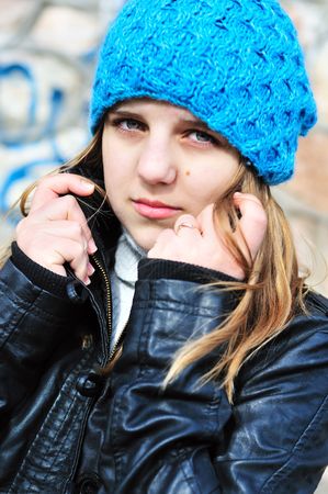 teen girl wearing blue hat and leather jacketの写真素材