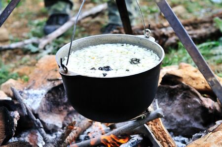  kettle with soup on fire in spring forest 
の写真素材