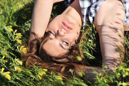 tender girl resting on the spring meadowの写真素材