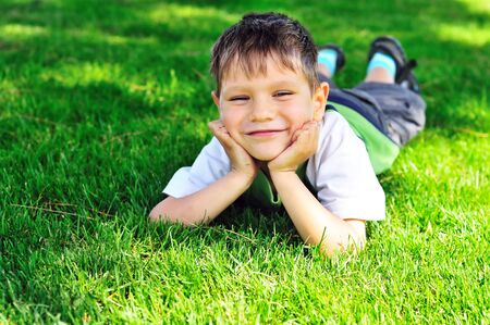happy little boy on the sunny meadowの写真素材