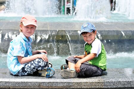 two little boys playing near waterworks;の写真素材