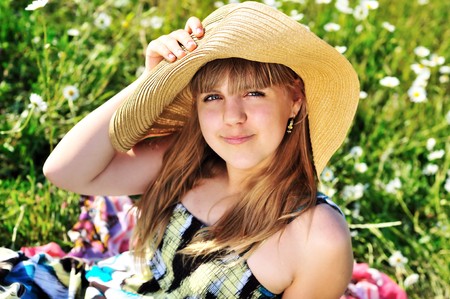 sweet teen girl laying on the daisy meadowの写真素材
