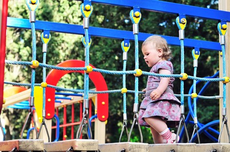 Little baby girl walking on playground in the park の写真素材