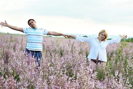 happy couple in waiting for baby  in fieldの写真素材