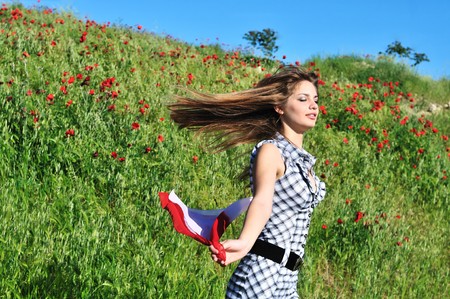 attractive tten girl running in poppy fieldの写真素材