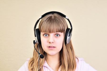 surprised teen girl with headphone on the headの写真素材