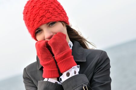 girl wearing  reg hat and red gloves outdorsの写真素材