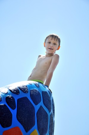 little wet boy wants to get out from swimming pool の写真素材