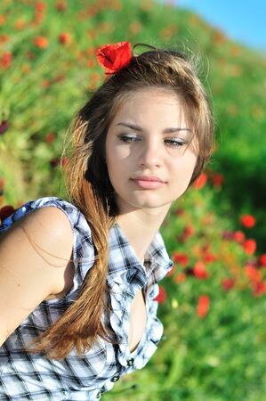 young sensual spring girl in the poppies field の写真素材