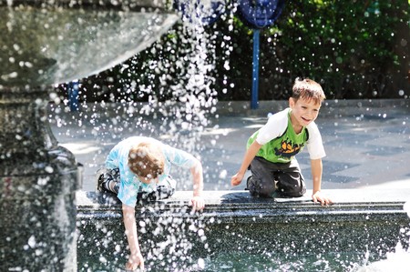 two little boys playing near the waterworksの写真素材