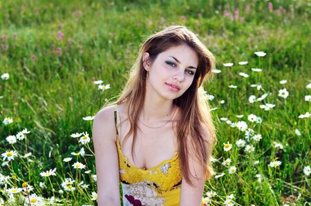  tender attractive girl relaxing  in the daisy field の写真素材