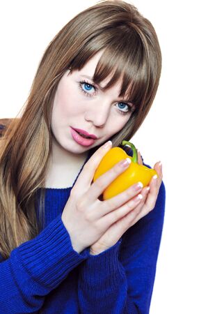 cute longhaired  girl with orange fresh pepper の写真素材