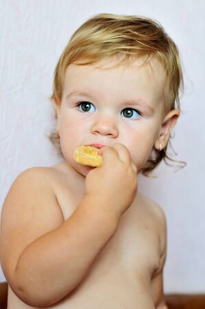 toddler funny girl eating  sweet cakeの写真素材