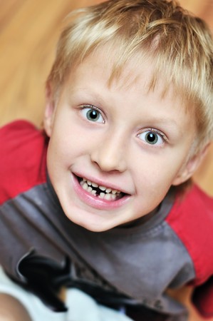 little boy showing that he lost first milk tooth の写真素材