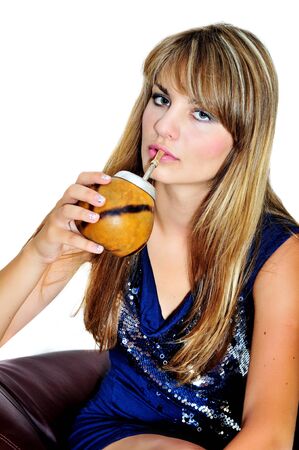 girl drinking mate she using calabash and bombilla の写真素材