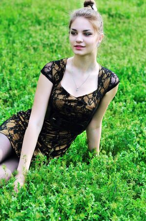 stunning beauty girl sitting in the high green grass の写真素材
