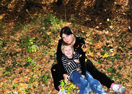 mother and son have a fun in the forest during leaf shedding の写真素材