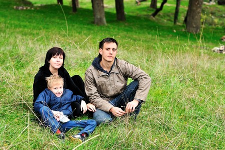 family with funny son in the forest during early autumnの写真素材