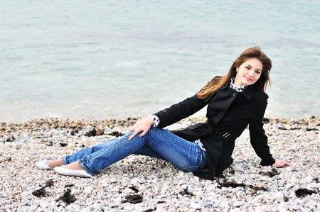 thoughtful calm girl relaxing on the beach の写真素材