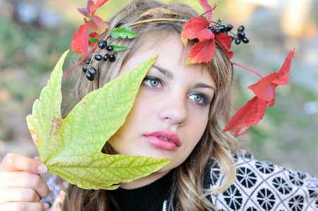 face of tender girl wearing autumn crown の写真素材