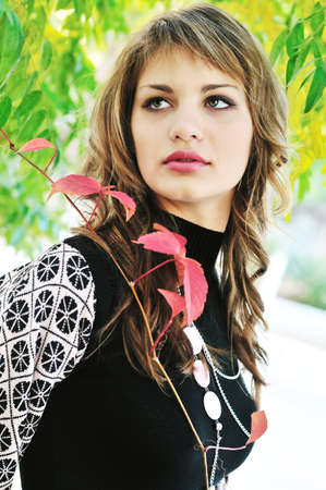 sweet girl in fall park  and looking upの写真素材