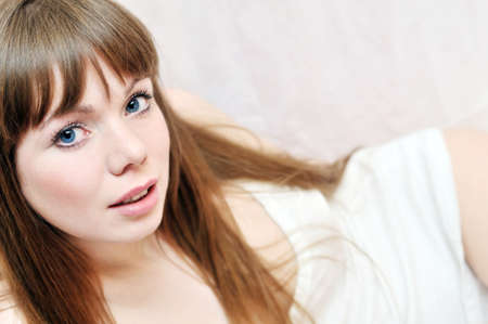 Portrait of young beauty laying woman with blue eyesの写真素材