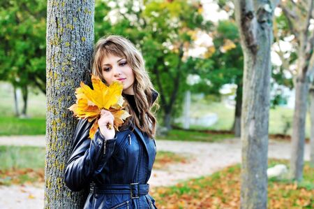tender teen girl in the autumn parkの写真素材