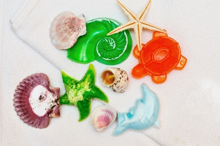 different homemade soaps with shells on the towelの写真素材