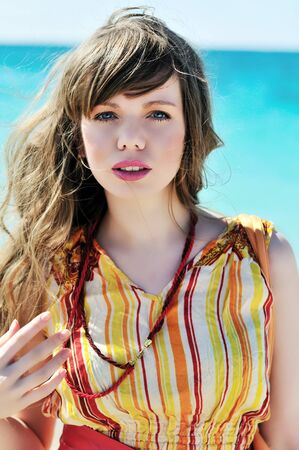 portrait of summer beautiful girl near the sea の写真素材